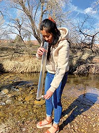 Jenna LinLi Hawks performing water quality testing for the U.S. Geological Survey (USGS).(Photo Credit: Steve Hawks)